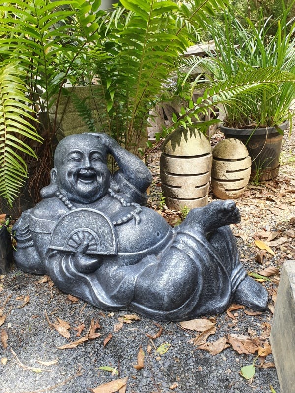 Laughing Buddha reclining 75x40x25cm - made from a stone composite material. Great for small gardens, decks and patios in apartments.