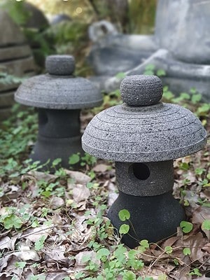 The Stone lantern 35x25cm CPS 85 is a hand-carved lava stone lantern designed for both interior and outdoor use. Add power or a candle for a special glow